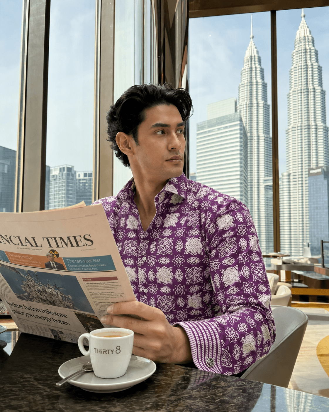 Concept image focused on a purple floral-patterned batik shirt with striped French cuffs.